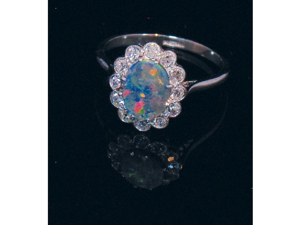 A BLACK OPAL AND DIAMOND DRESS RING the central oval