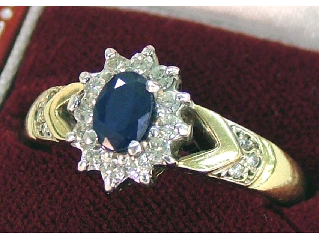 9ct oval sapphire cluster ring set with a band of