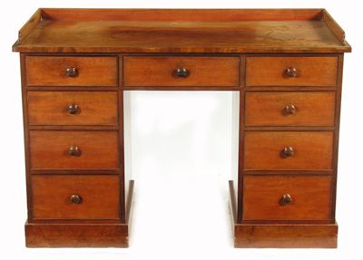 A Victorian mahogany kneehole dressing table with a three quarter