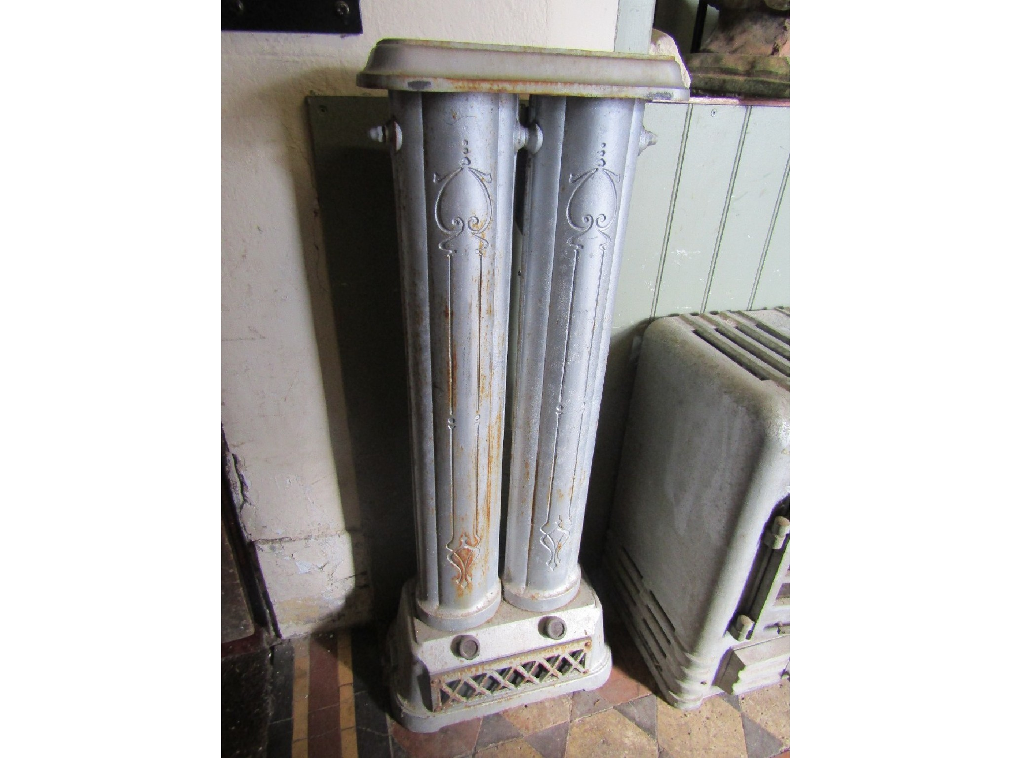 A vintage reclaimed cast iron floor standing vertical two bar