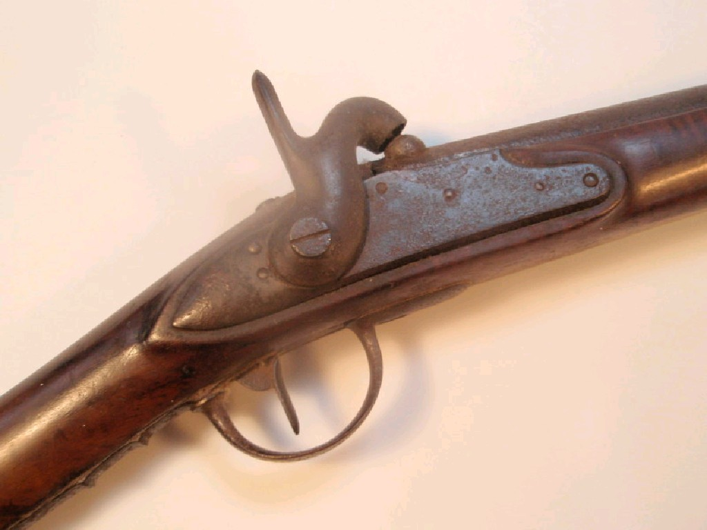 An antique single barrel percussion black powder rifle