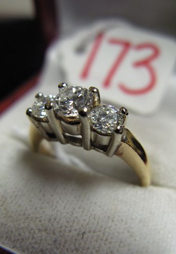 DIAMOND AND FOURTEEN YELLOW AND WHITE GOLD THREE STONE RING