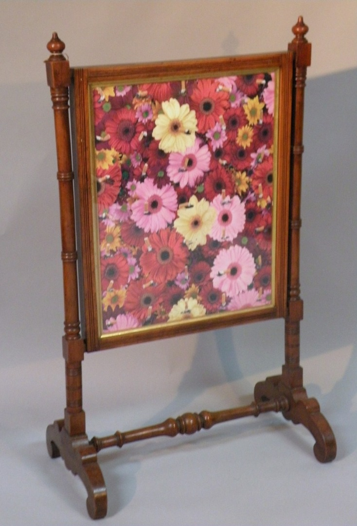 An early 20thC walnut fire screen the rectangular centre with