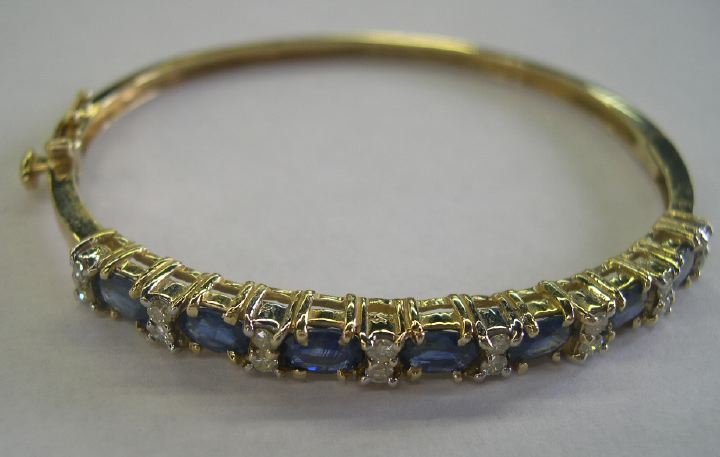 Fourteen Karat Yellow Gold Sapphire and Diamond Bangle Bracelet featuring