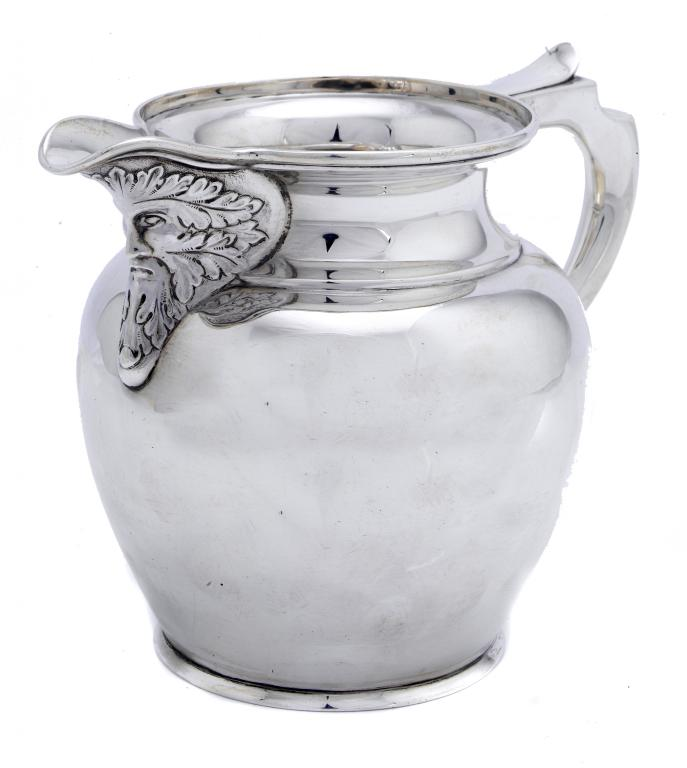 A GEORGE V MASK JUG of shouldered form with cavetto
