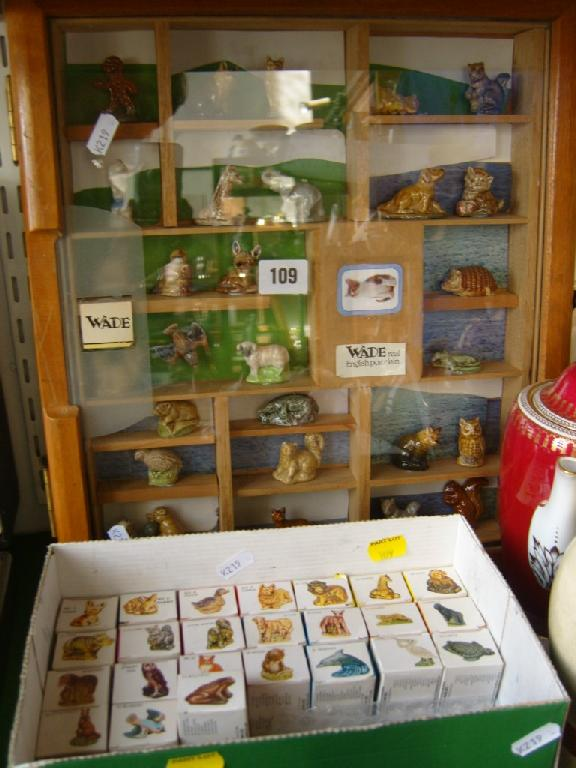 A display case containing a quantity of Wade Whimsies including