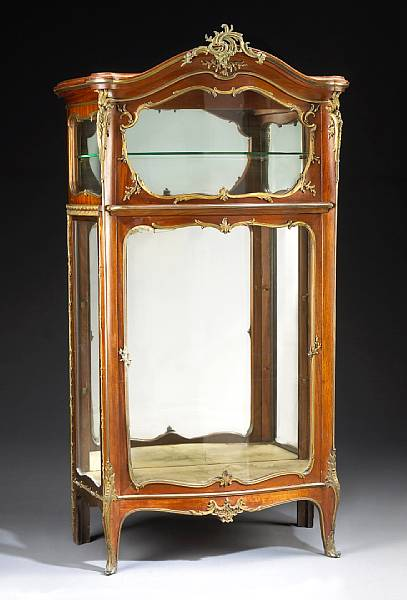 A Louis XVI style gilt bronze mounted mahogany vitrine cabinet