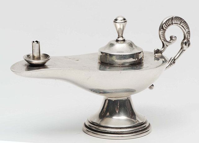 A CHILEAN SILVER TABLE CIGAR LIGHTER in the form of