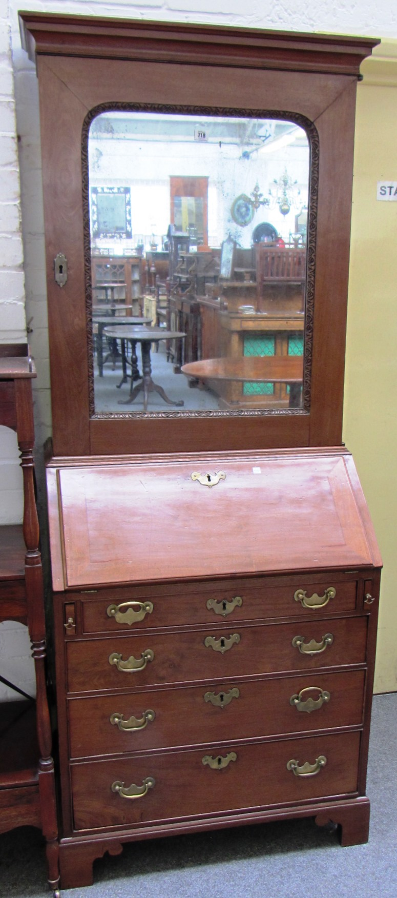 A mid 18th century mahogany bureau cabinet the single mirrored