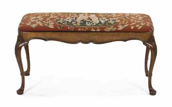 A Georgian Style Walnut Bench having a rectangular needlepoint upholstered