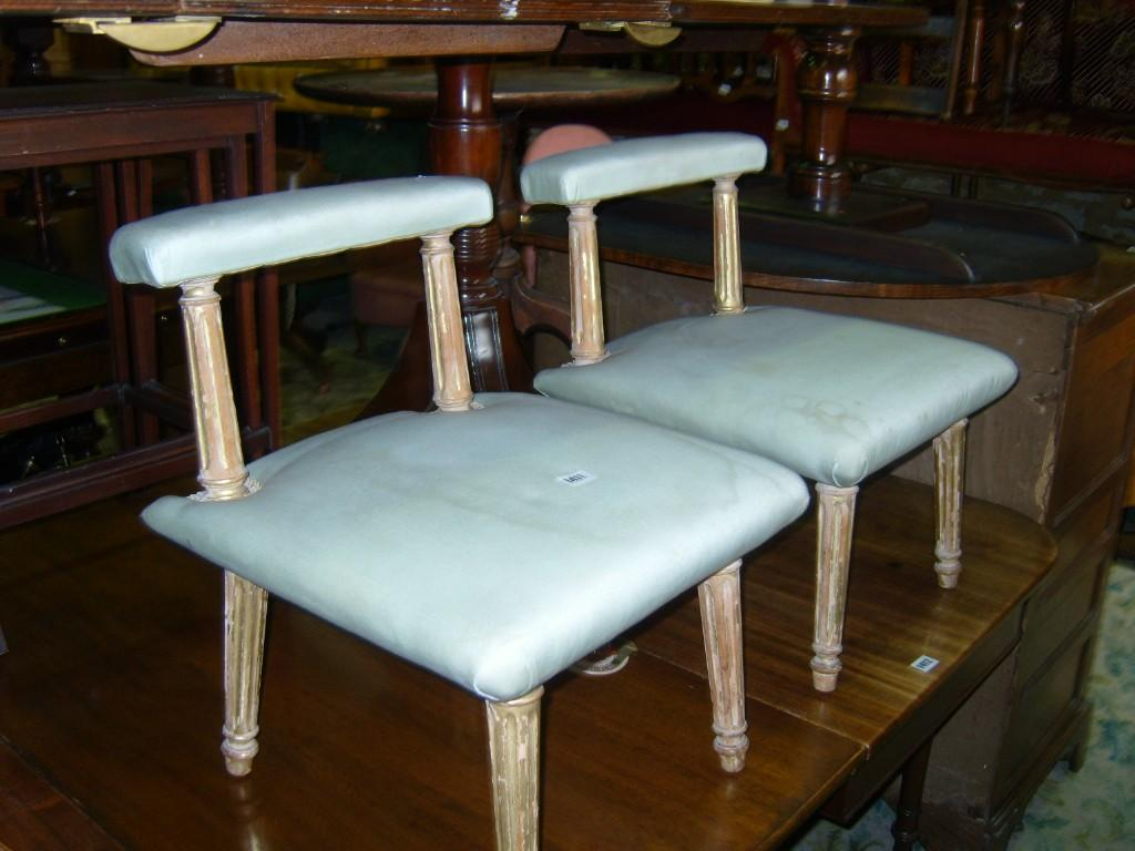A pair of low seated occasional chairs with upholstered seats