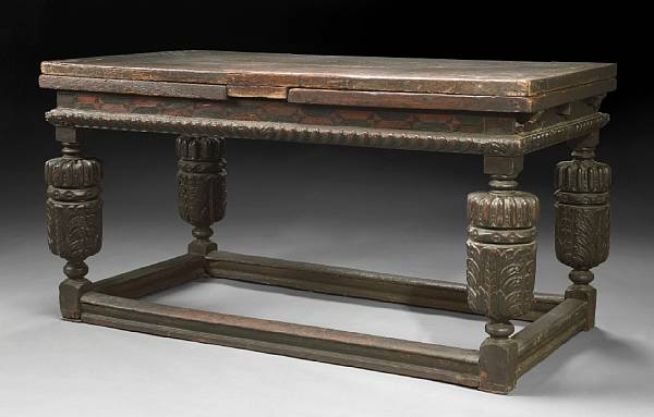 An Elizabethan style inlaid oak draw leaf refectory table incorporating