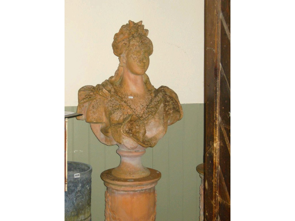 A pair of terracotta busts on stands of classical style