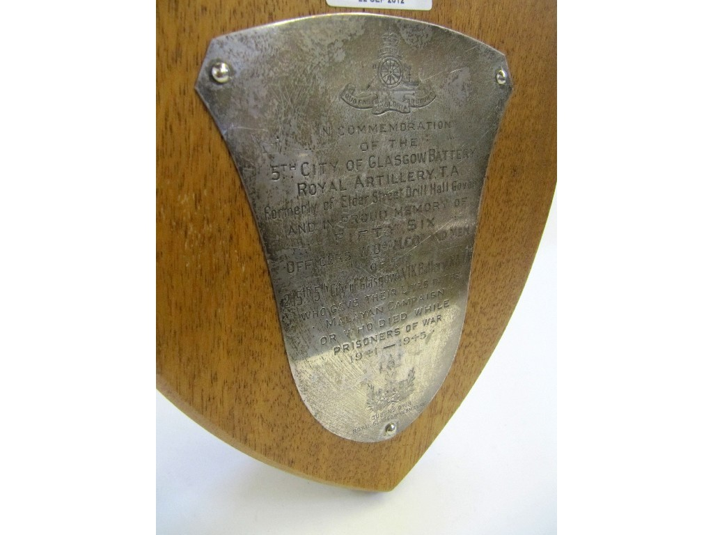A white metal plate on oak shield plaque engraved in