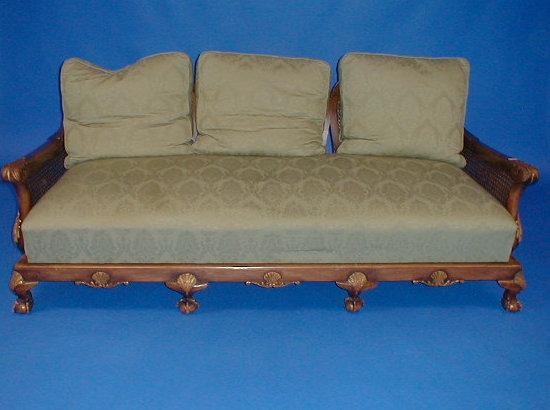 A carved walnut bergere three seater sofa with double caned