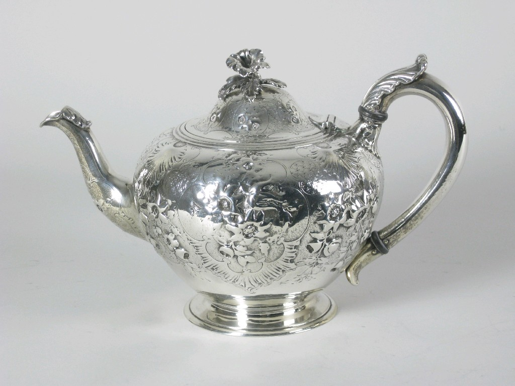 A Victorian Teapot floral embossed and engraved crest flower finial