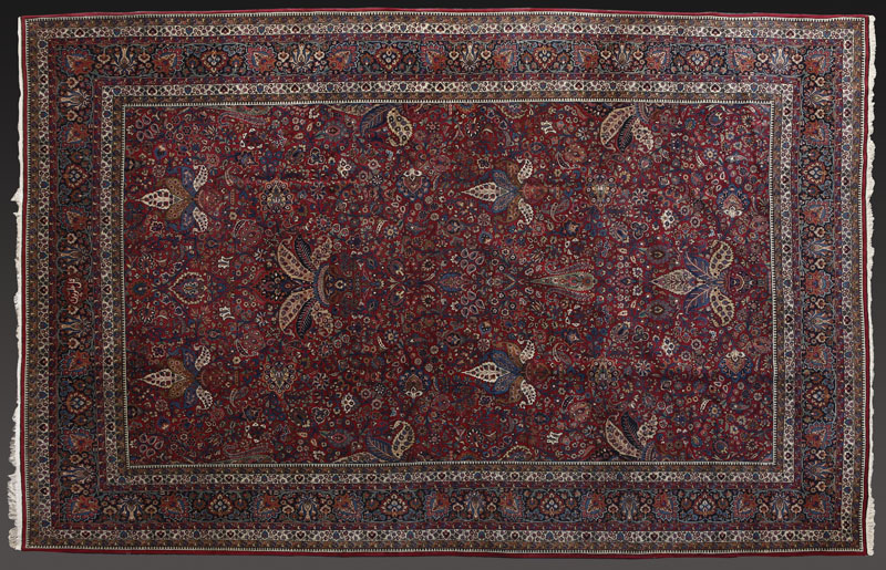 A Persian Mashad woolen carpet rug A Persian Mashad woolen