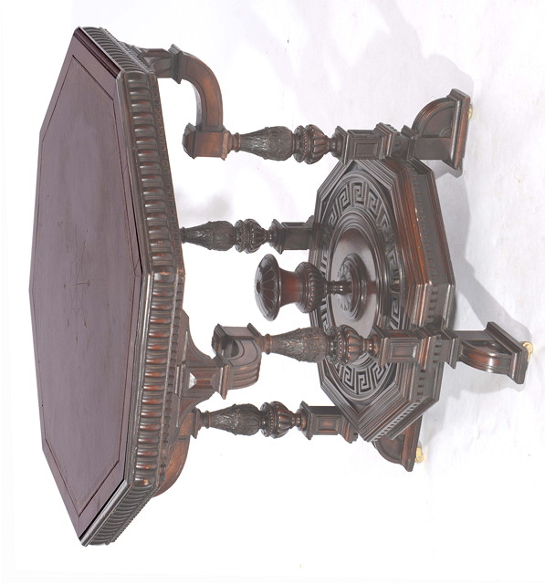 A VICTORIAN MAHOGANY OCTAGONAL LIBRARY TABLE inset a tooled leather