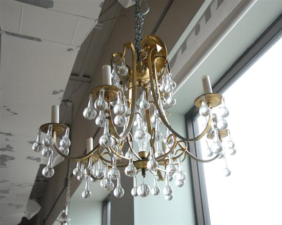 A Brass and Glass Six Arm Chandelier the brass framework