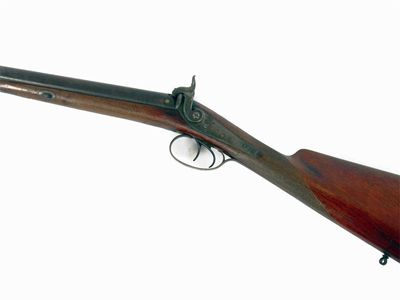 A double barrel percussion carbine with a walnut stock and