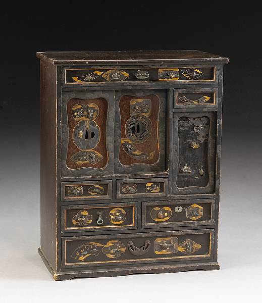 A small tansu decorated with tsuba and sword fittings Meiji