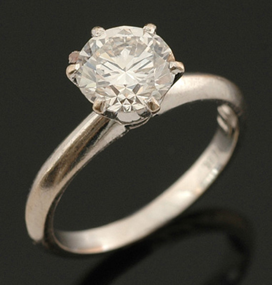 A solitaire diamond ring The round brilliant cut diamond weighing