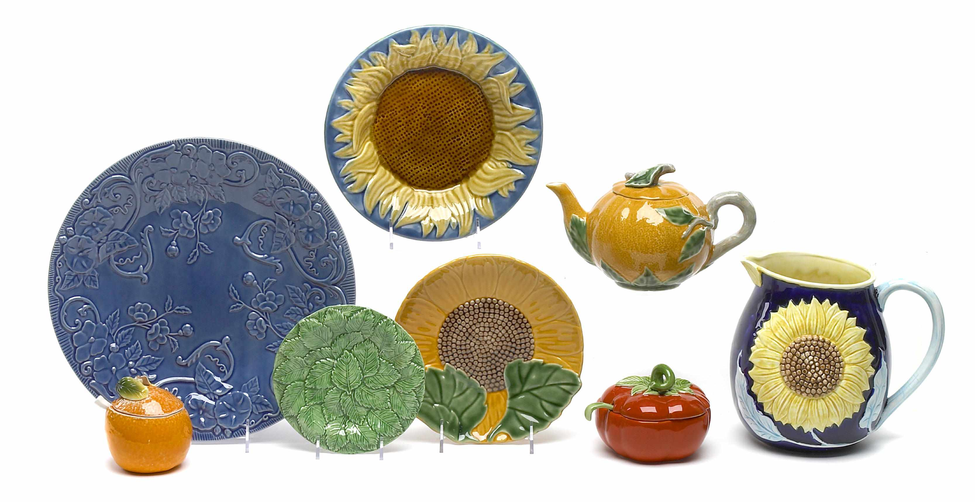 An assortment of paint decorated and glazed pottery dinnerware items