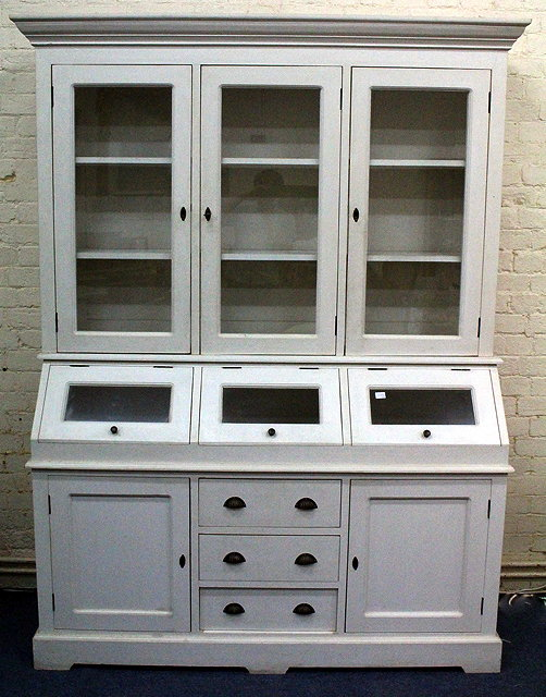 A WHITE PAINTED DRESSER with glazed cupboard above enclosing two