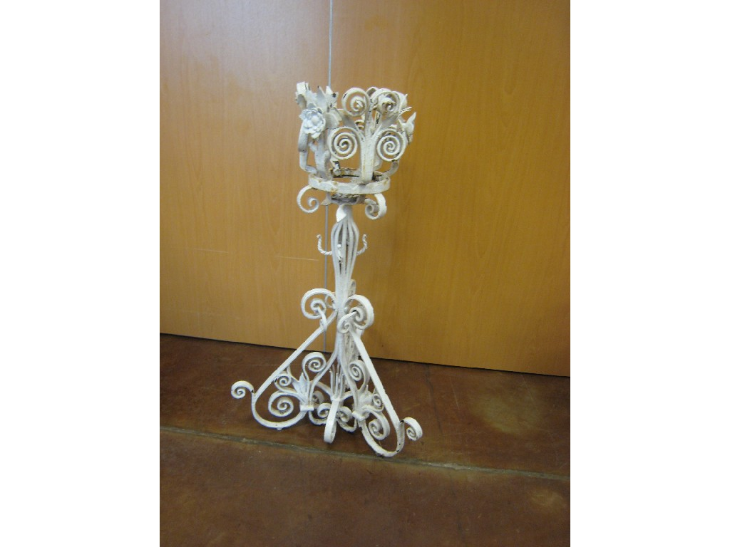 A freestanding painted wrought iron Planter scrollwork designs