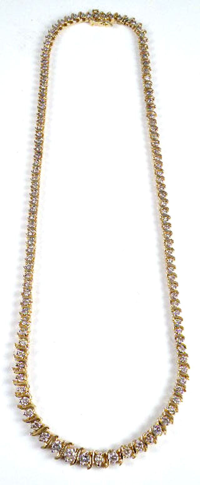 DIAMOND AND FOURTEEN KARAT GOLD LINE NECKLACE with S form