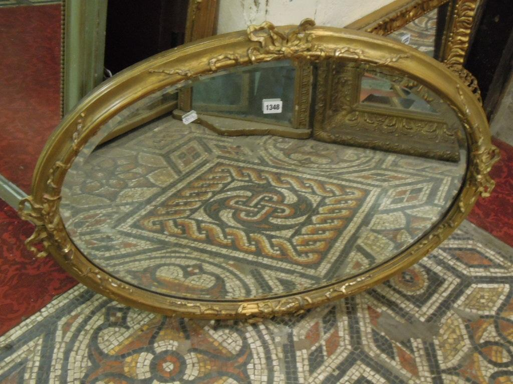 A Victorian gilt framed wall mirror of oval form with