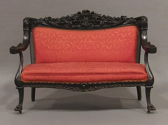 Settee back with deeply carved bow tied ribbons flowers and