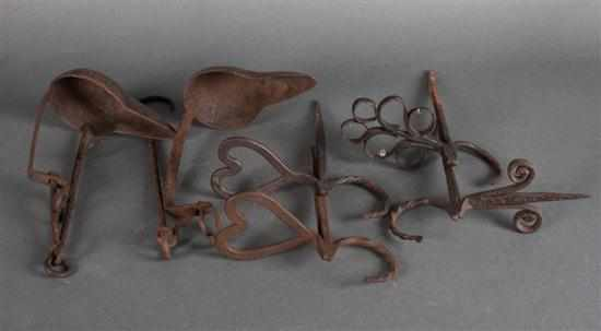 Two 18th century cast iron hanging Betty lamps and four