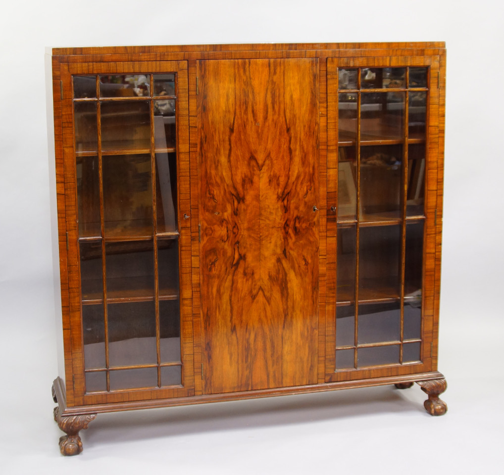 A walnut bookcase early 20thC with a central quarter veneered