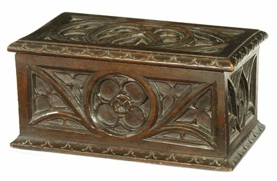 A carved and stained wood boarded box in Gothic taste