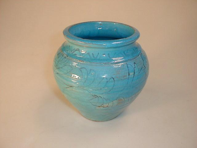 A turquoise stoneware bulbous vase with stylised hare decoration