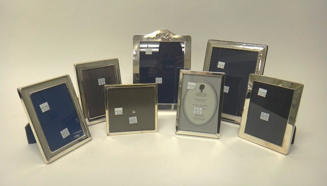 A silver mounted rectangular photograph frame the top with a