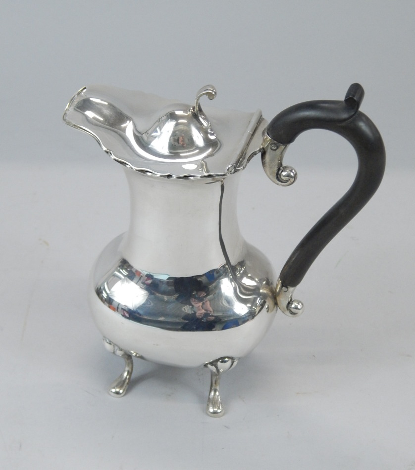 A small Edwardian hot water jug with a hinged lid