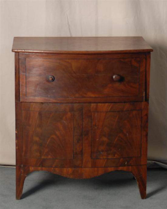 A Late Georgian Bow front Mahogany Commode with ebony stringing