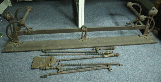 An Art Nouveau style fender and fire irons