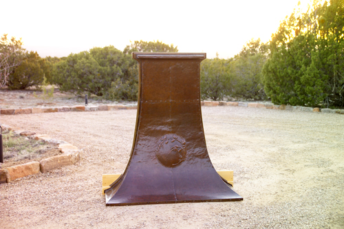 GUSTAV STICKLEY Hammered copper fireplace hood embossed with a pine