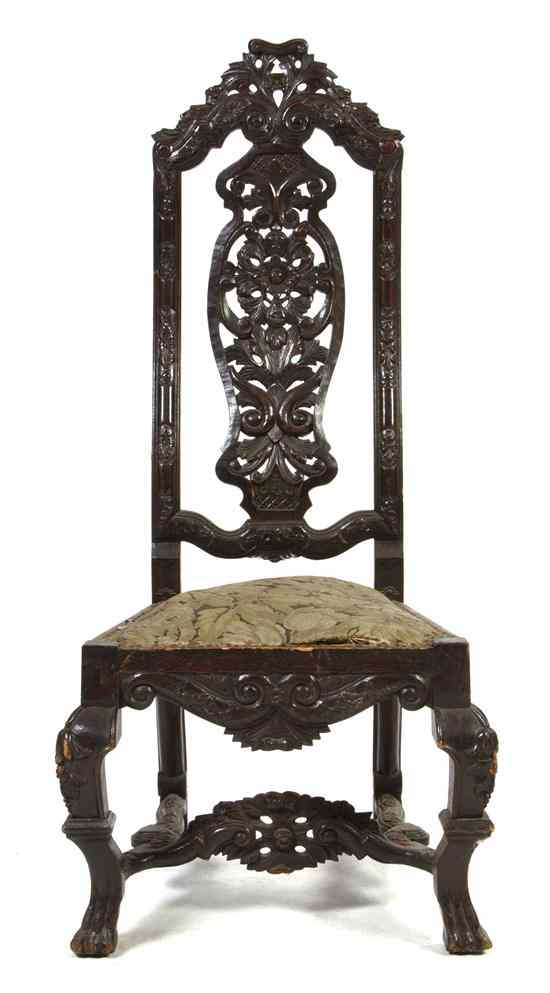 A Renaissance Revival Carved Hall Chair having pierce carved crest