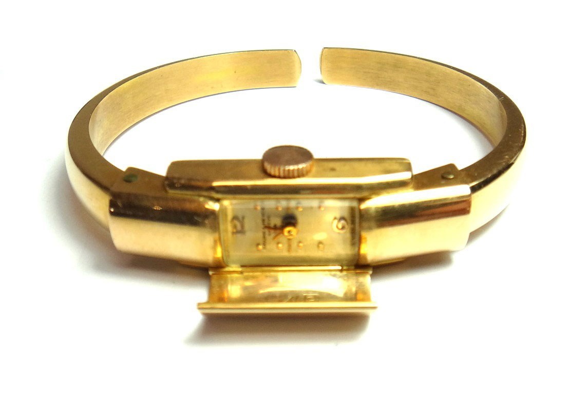 A lady s gold cased Baume Mercier bangle wristwatch the