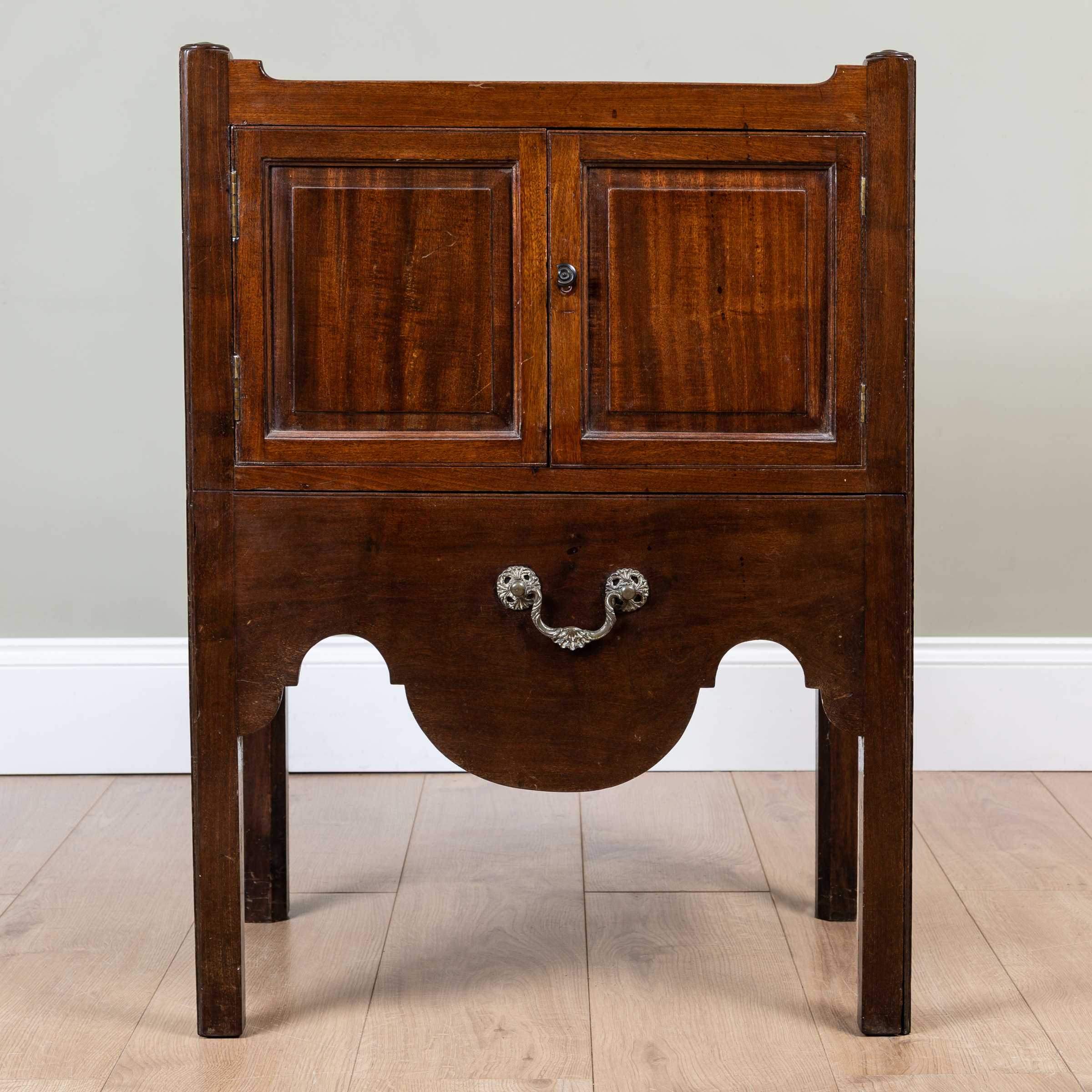 A George III mahogany pot cupboard with galleried top over