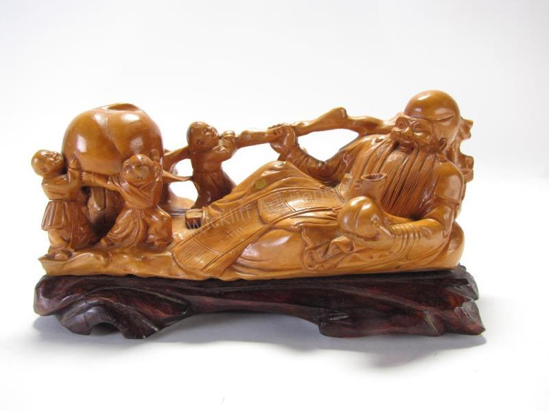 Carved Wood Figure of Confucius depicting a reclining Confucius being