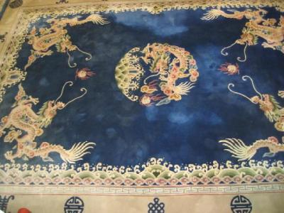 A CHINESE WASHED AND FRINGED CARPET 20th century the Royal