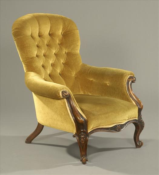 A Victorian walnut button back armchair circa 1860 the scroll