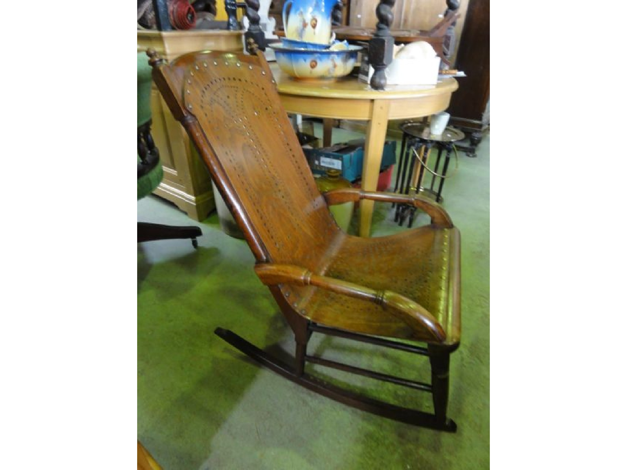 A late Victorian mahogany framed rocking chair with pierced plywood