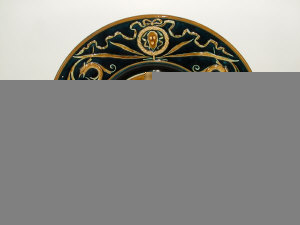 Austrian pottery wall charger with central moulded figural decoration and