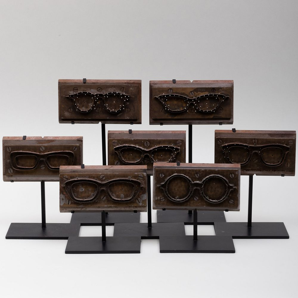 Group of Seven Metal Eye Glass Molds Raised on stands